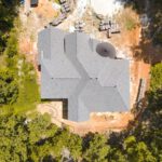 Construction Drone - a large stone building surrounded by trees