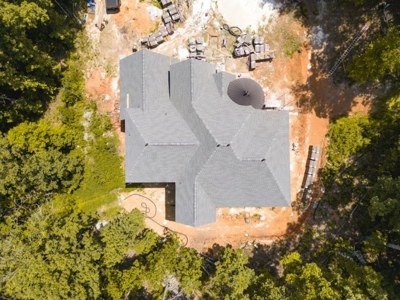 Construction Drone - a large stone building surrounded by trees