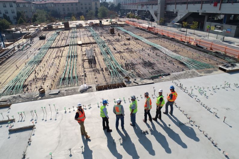Augmented Reality Construction - seven construction workers standing on white field