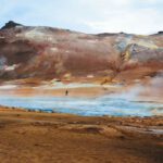 Geothermal System - a man standing in the middle of a body of water
