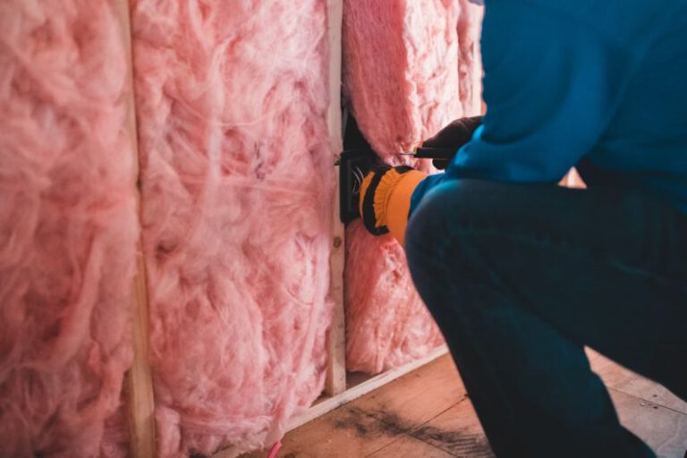 Thermal Insulation - person in blue pants sitting on brown wooden floor